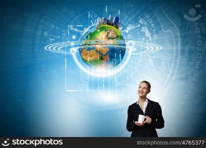 Innovative technologies. Attractive businesswoman looking at Earth planet. Elements of this image are furnished by NASA