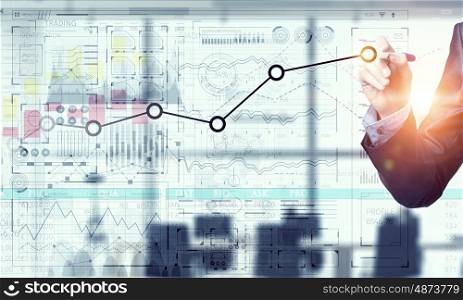 Innovative technologies for business. Businessman hand drawing increasing graph on media screen