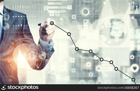 Innovative technologies for business. Businessman hand drawing increasing graph on media screen