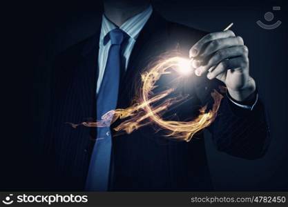 Innovative technologies for your business. Hand of businessman drawing burning euro sign on media screen