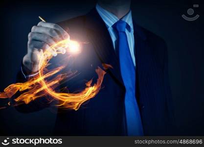 Innovative technologies for your business. Hand of businessman drawing burning euro sign on media screen