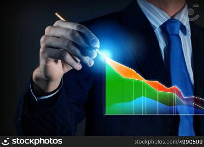 Innovative technologies for your business. Hand of businessman drawing virtual infographs on media screen