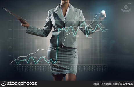 Innovative technologies for your business. Hand of businesswoman drawing virtual infographs on media screen