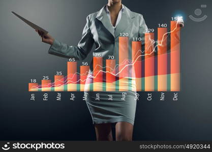 Innovative technologies for your business. Hand of businesswoman drawing virtual infographs on media screen