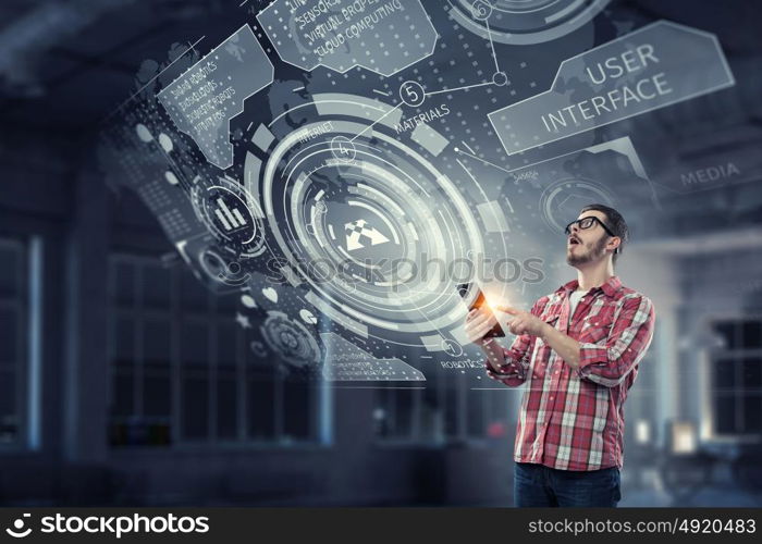 Innovative technologies for your device. Hipster guy in checked shirt using his tablet pc