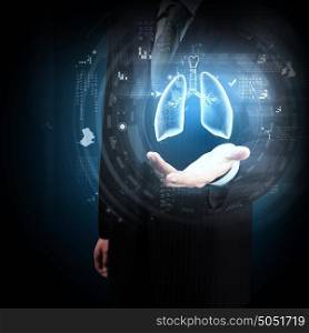 Innovative technologies in medicine. Close up of businessman and hologram of human lungs in his palm