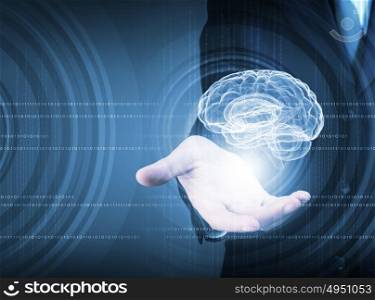 Innovative technologies in medicine. Close up of businessman holding digital image of brain in palm
