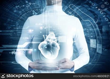 Innovative technologies in medicine. Close up of young man body and digital images of heart