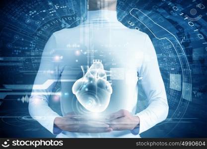 Innovative technologies in medicine. Close up of young man body and digital images of heart