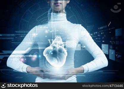 Innovative technologies in medicine. Close up of young woman body and digital images of heart