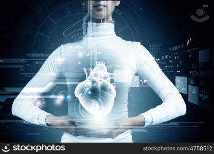 Innovative technologies in medicine. Close up of young woman body and digital images of heart