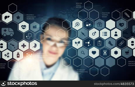 Innovative technologies in medicine. Young female doctor looking at media screen