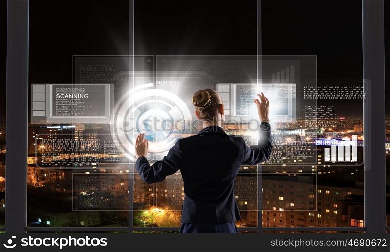 Innovative technologies. Rear view of businesswoman touching icon of media screen