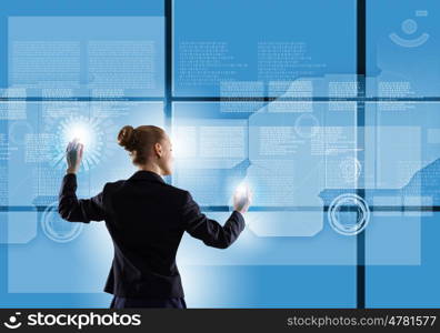 Innovative technologies. Rear view of businesswoman touching icon of media screen