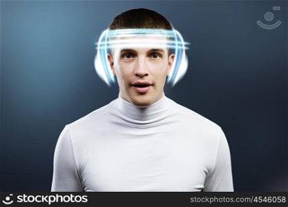 Innovative technologies. Young handsome man in glasses and virtual headphones