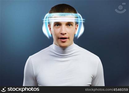 Innovative technologies. Young handsome man in glasses and virtual headphones