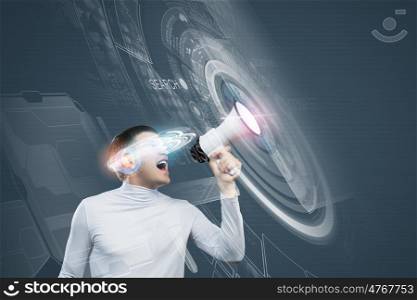 Innovative technologies. Young handsome man screaming in megaphone. Media concept