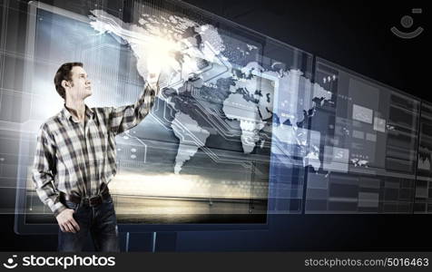 Innovative technologies. Young man in casual touching icon of media screen