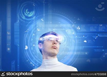 Innovative technologies. Young man wearing futuristic glasses against blue background