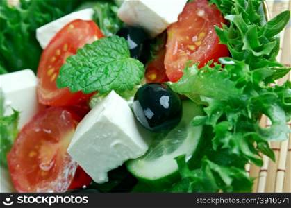 Insalata di misticanze - leaves of different salads with vegetables and Sicilian tomatoes