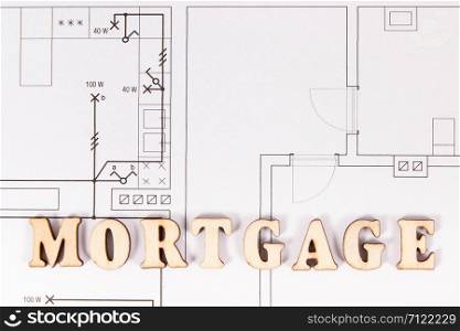 Inscription mortgage on construction diagrams of housing plan, concept of buying house. Inscription mortgage on construction housing plan, buying house concept