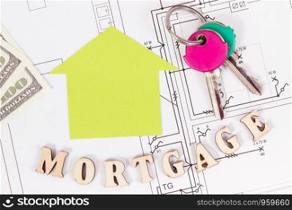Inscription mortgage with currencies dollar and home keys on construction diagrams of housing plan, concept of buying house. Inscription mortgage with currencies dollar and keys on construction housing plan, buying house concept