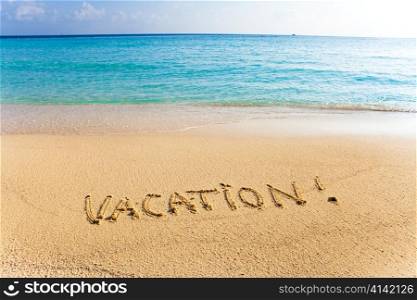 Inscription on sand &acute;vacation&acute;