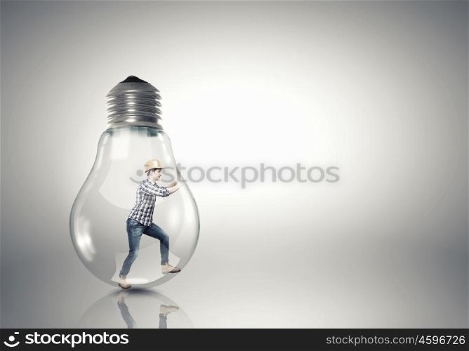 Inside light bulb. Builder man inside light bulb trying to get out