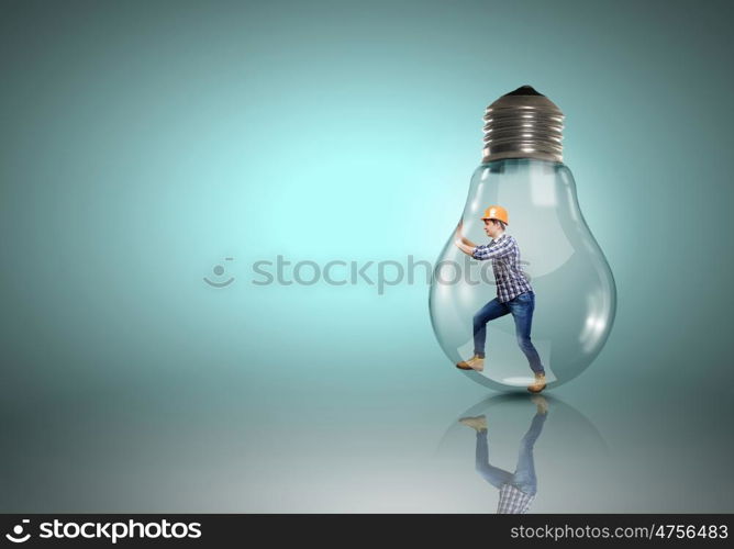 Inside light bulb. Builder man inside light bulb trying to get out