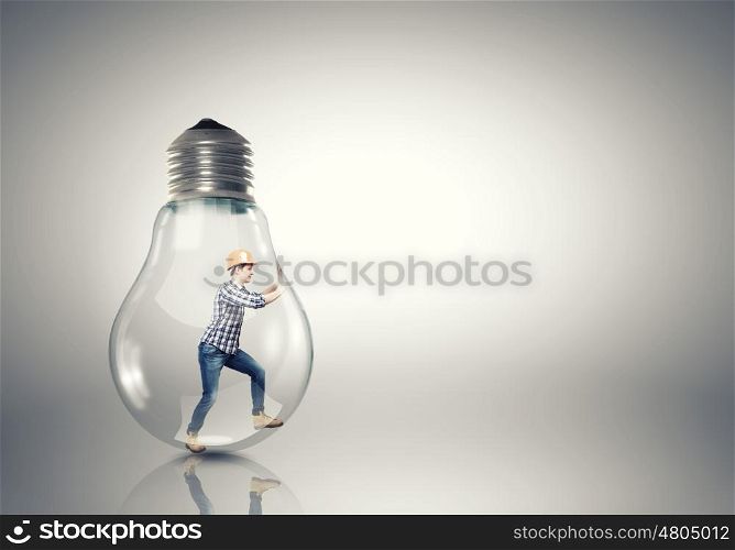 Inside light bulb. Builder man inside light bulb trying to get out