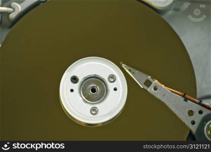 Inside of a desktop computer hard drive showing the platters and read-write arm and head.
