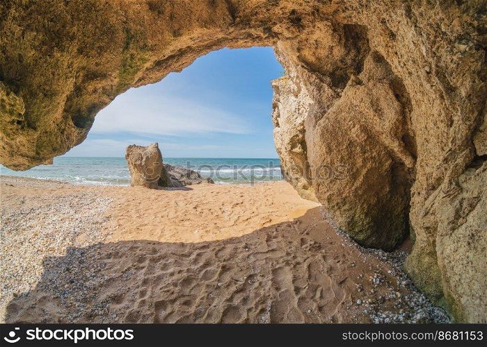 Inside of grotto at day on the sea shore. Nature composition.