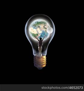 Inside of idea. Cheerful girl inside of glass light bulb. Elements of this image are furnished by NASA