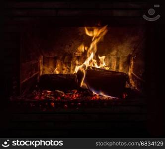 inside of stove with fire and glowing embers