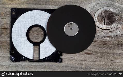 Inside parts of a computer diskette or floppy disk on rustic wood