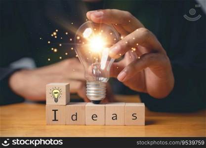 Insight and discovery concept. Person holding wooden block with light bulb icon, suggesting a breakthrough with copy space. Business intelligence for productive transformation. new ideas
