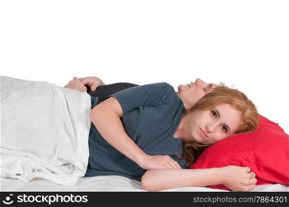 Insomniac woman laying next to sleeping man