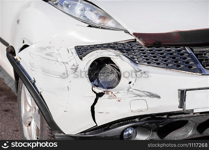 Inspection of the car after an accident on the road. The front fender and left headlight are broken, damaged and scratched on the bumper. Accident.. Inspection of the car after an accident on the road. The front fender and left headlight are broken, damaged and scratched on the bumper.