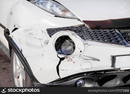 Inspection of the car after an accident on the road. The front fender and left headlight are broken, damaged and scratched on the bumper. Accident.. Inspection of the car after an accident on the road. The front fender and left headlight are broken, damaged and scratched on the bumper.