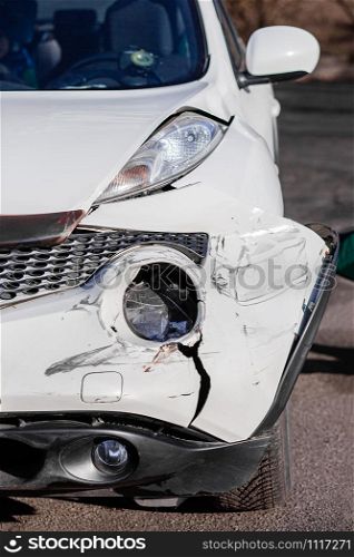 Inspection of the car after an accident on the road. Car accident or accident. The front wing and the right headlight are broken, damage and scratches on the bumper. Broken car parts or close-up.. Car accident or accident. The front wing and the right headlight are broken, damage and scratches on the bumper. Broken car parts or close-up.
