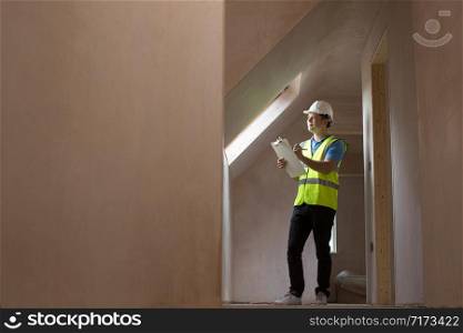 Inspector On Building Site With Clipboard