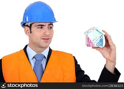 Inspector with a house made of money