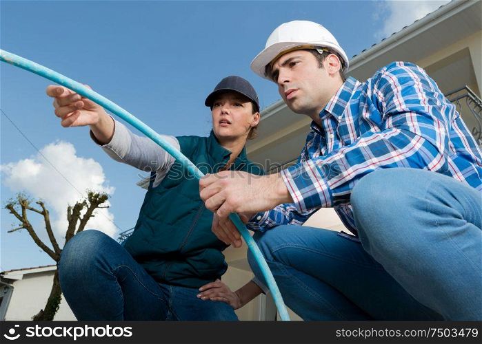 inspectors inspecting outdoor electrical tube