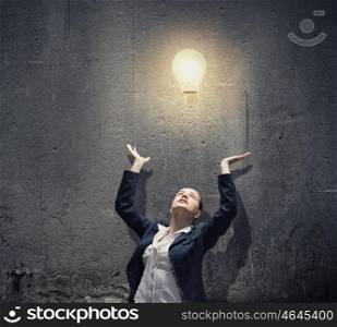 Inspiration and idea. Image of businesswoman and electrical bulb. New idea