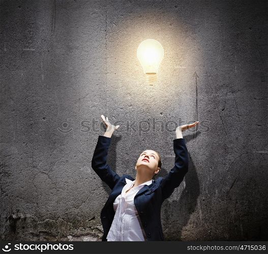 Inspiration and idea. Image of businesswoman and electrical bulb. New idea