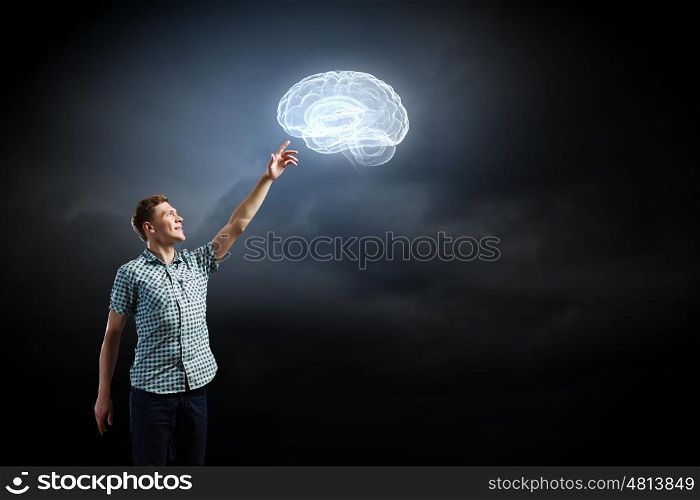 Inspiration concept. Young man and brain illustration against dark background