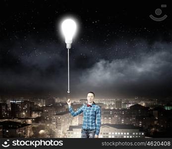 Inspiration concept. Young woman in casual holding bulb balloon. Idea concept