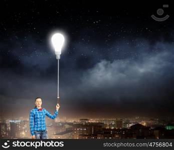 Inspiration concept. Young woman in casual holding bulb balloon. Idea concept