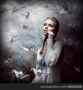 Inspiration. Woman with Flying White Origami Swans in Dark Mystic Forest