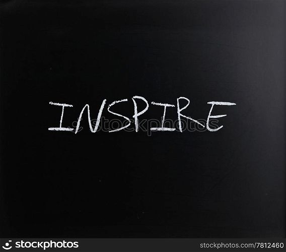 ""Inspire" handwritten with white chalk on a blackboard."